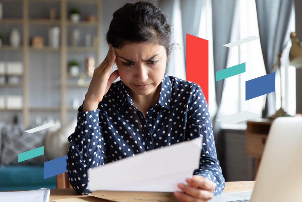 Woman reviewing documents at a desk, focusing on business setup.