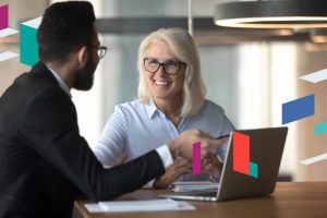 Two professionals discussing business setup at a table.