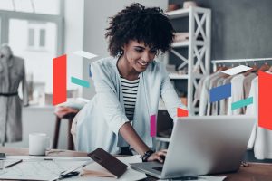 Woman working at desk with laptop, exploring business setup in UAE.