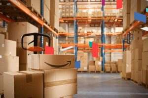 Warehouse with stacked boxes, including one with an Amazon logo.