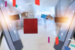 Digital transaction and shopping concept with screens exchanging bag and card.
