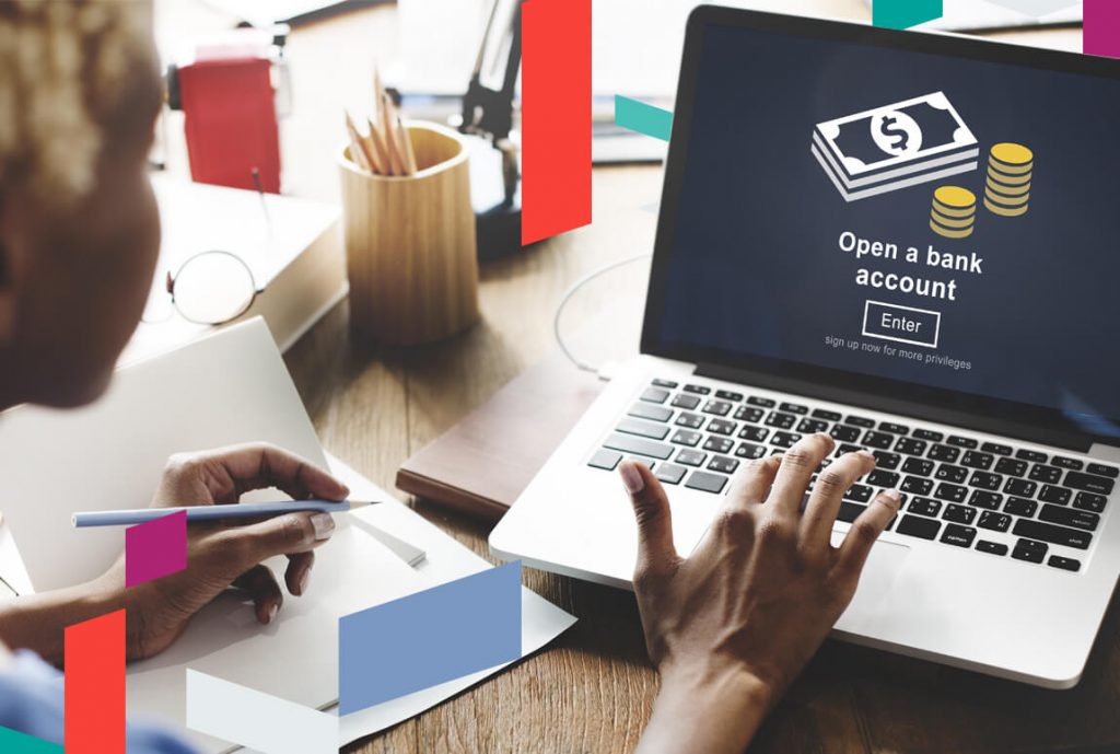 Person using laptop with screen showing 'Open a bank account' and banknotes graphic.