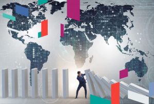 Businessman stopping falling blocks with a world map background.