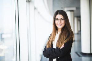Businesswoman standing confidently in a modern office environment.
