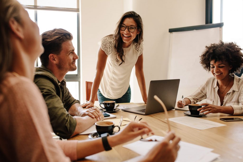 Team of four discussing business setup in a modern office.
