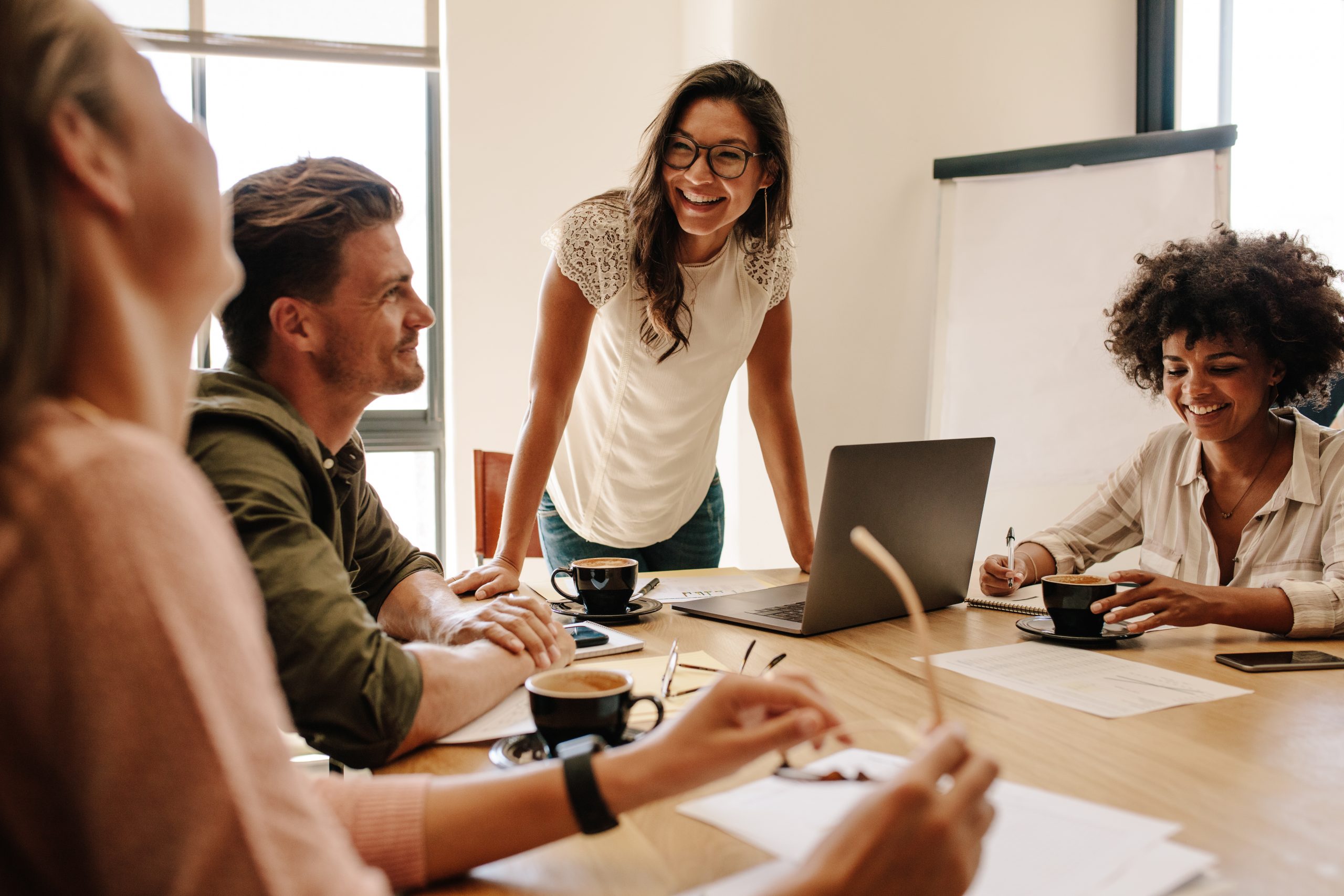 Team of four discussing business setup in a modern office.