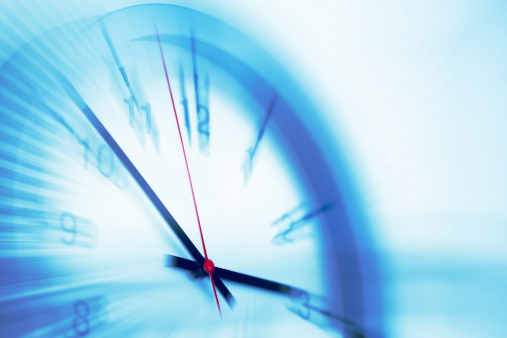 Blurred clock symbolizing urgency and efficiency in business.