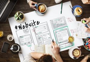 Group planning website layout with sketches and notes.