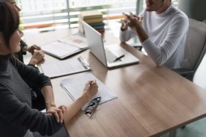 People discussing business setup in UAE at a conference table.