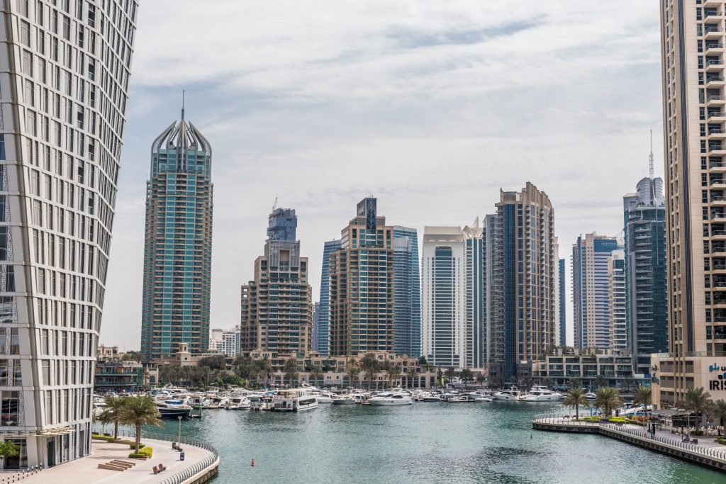 Skyline of business district in Dubai with high-rise buildings and marina.