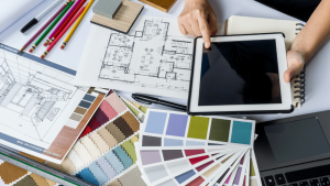 Business planning with tablet, color swatches, and architectural plans.