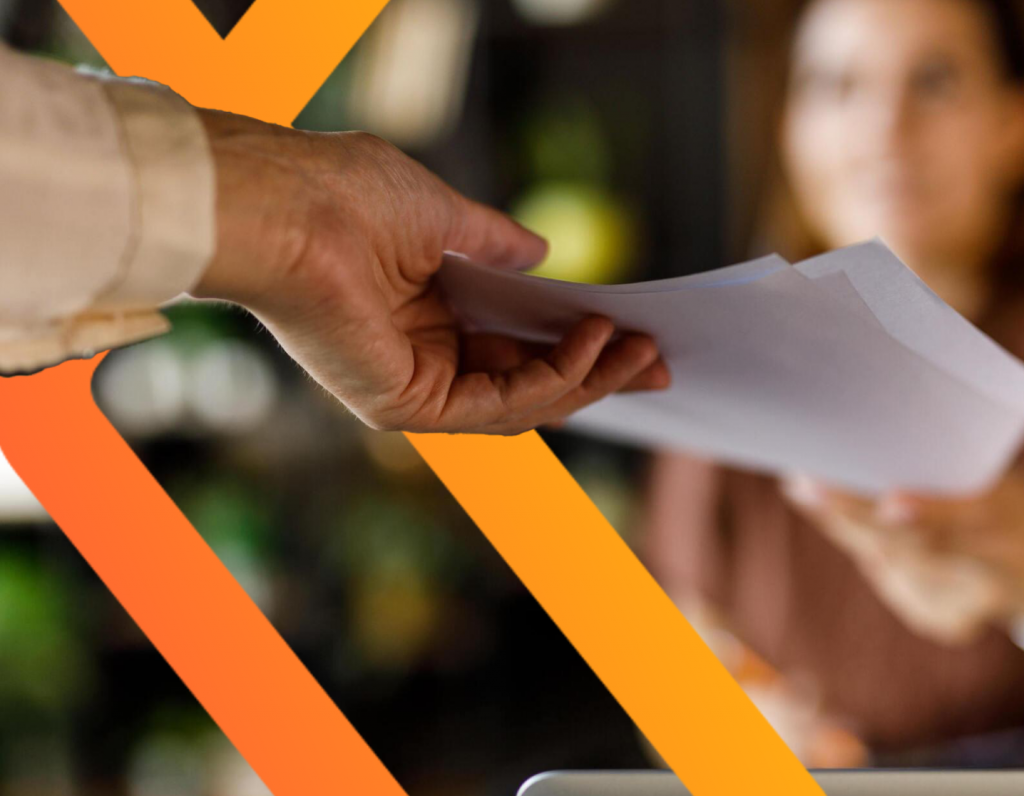 Hand passing documents for UAE free zone company setup.
