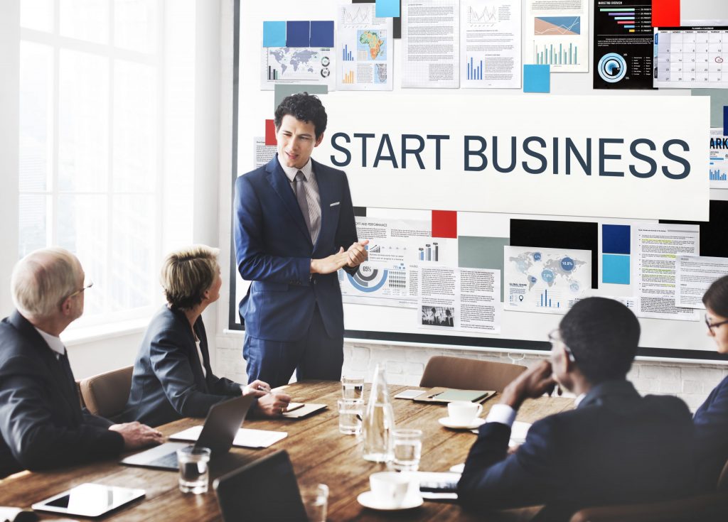 Business meeting discussing starting a business in UAE free zones.
