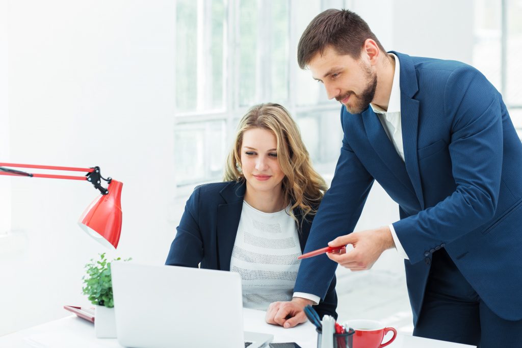 Two professionals discussing free zone business setup in UAE.